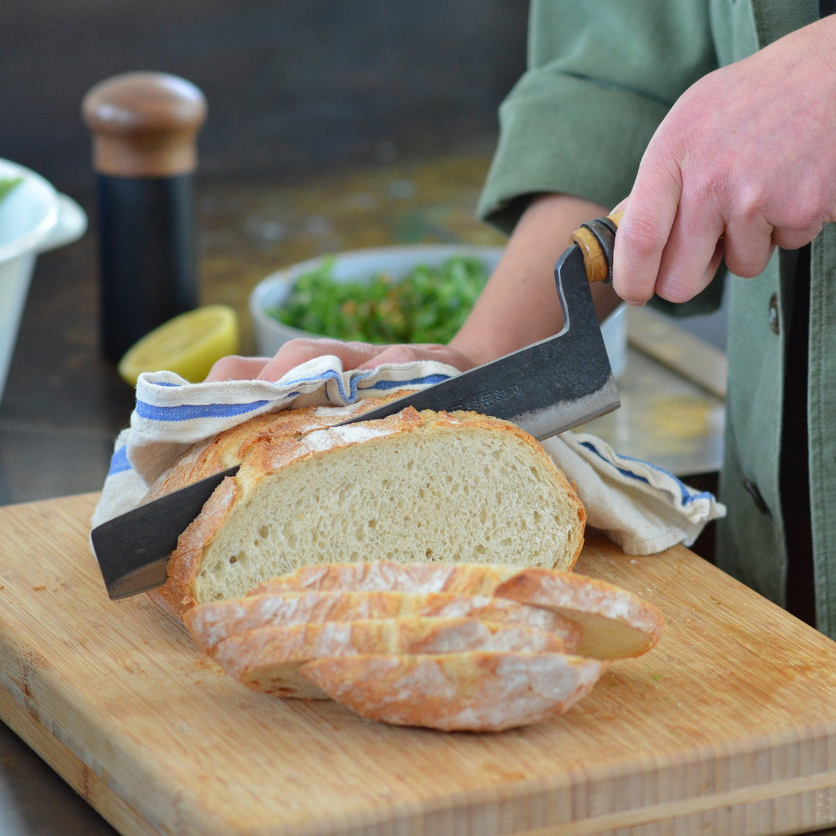 Master Shin's Anvil, #57 Rustic Bread Knife - Lifestyle Photo bread cutting