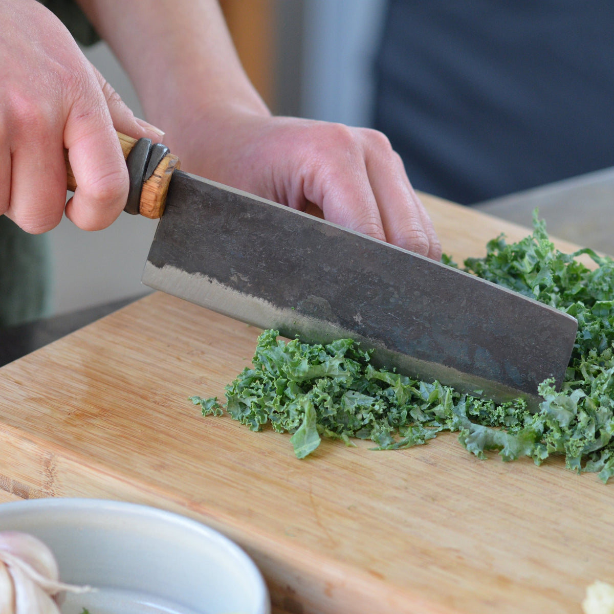 Master Shin's Anvil, #63 Vegetable Knife, lifestyle photo of chopping kale
