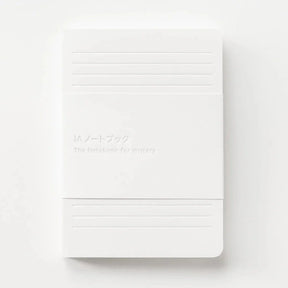 White notebook with horizontal lines on a white background