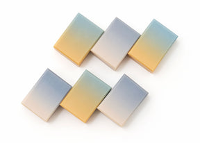 Six rectangular gradient tiles in pastel shades of blue, yellow, and beige, arranged in two rows on a white background.