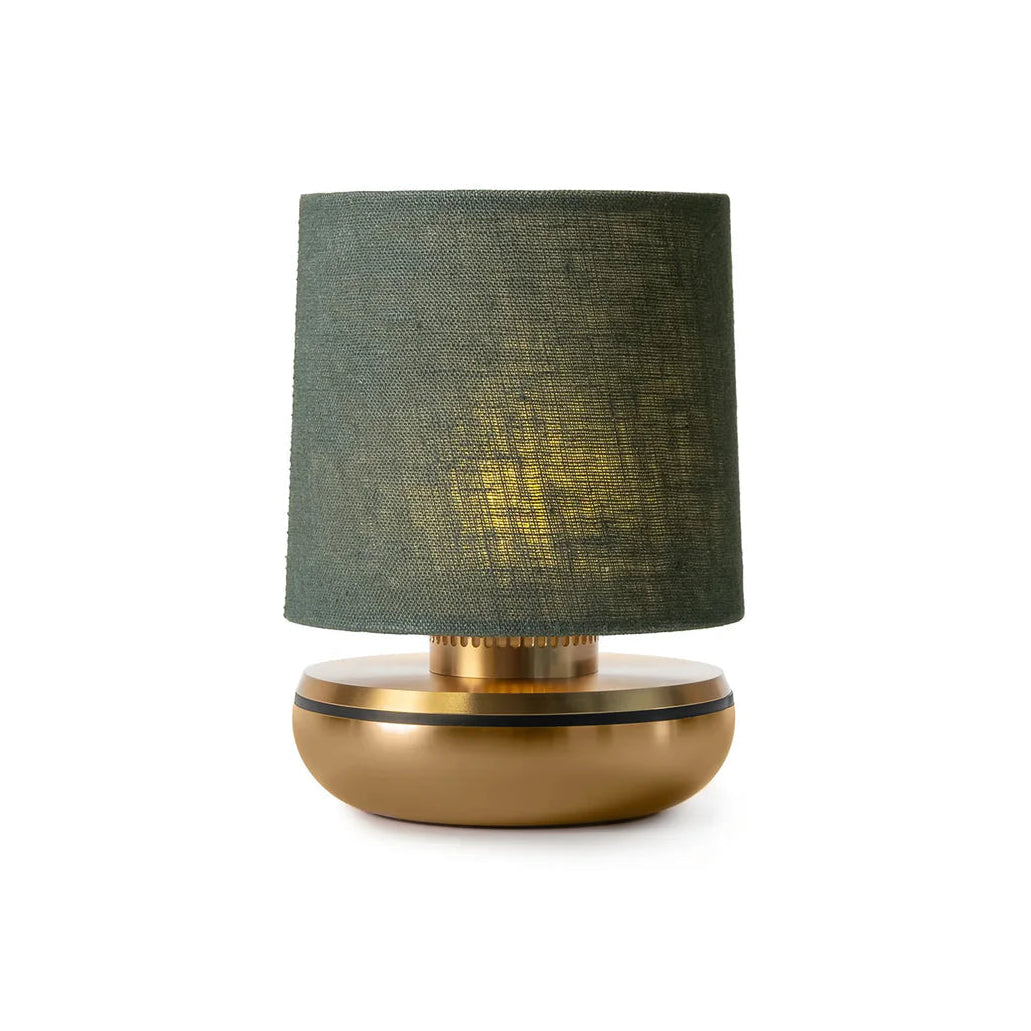 Table lamp with green shade and gold base on a white background