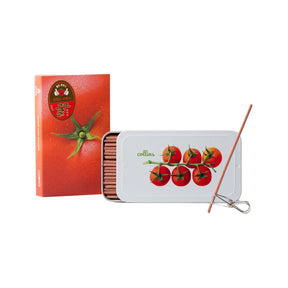 A set of tomato-themed incense sticks  in a white metal tin with a red tomato illustration