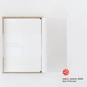 White product packaging with gold text on a light gray background, featuring Red Dot Award logo.