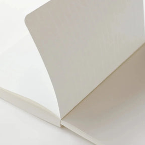 Close-up of a white notebook on a white background