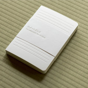 White rectangular device with text on a textured beige surface
