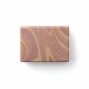 A rectangular bar of soap with a marbled swirl pattern in dusty rose, terracotta, and cream, shown on a clean white background with a soft drop shadow.