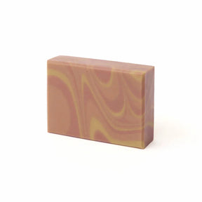 Marbled pink and yellow soap bar on a white background
