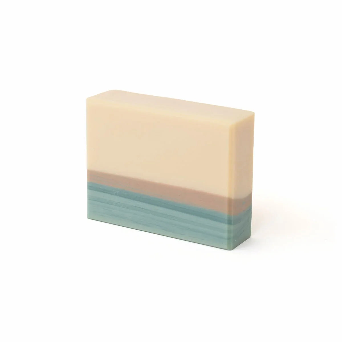 Bar of soap with layered colors on a white background